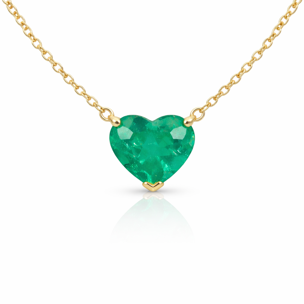 Close-up of a heart-cut green emerald set in white gold and suspended from a fine chain.