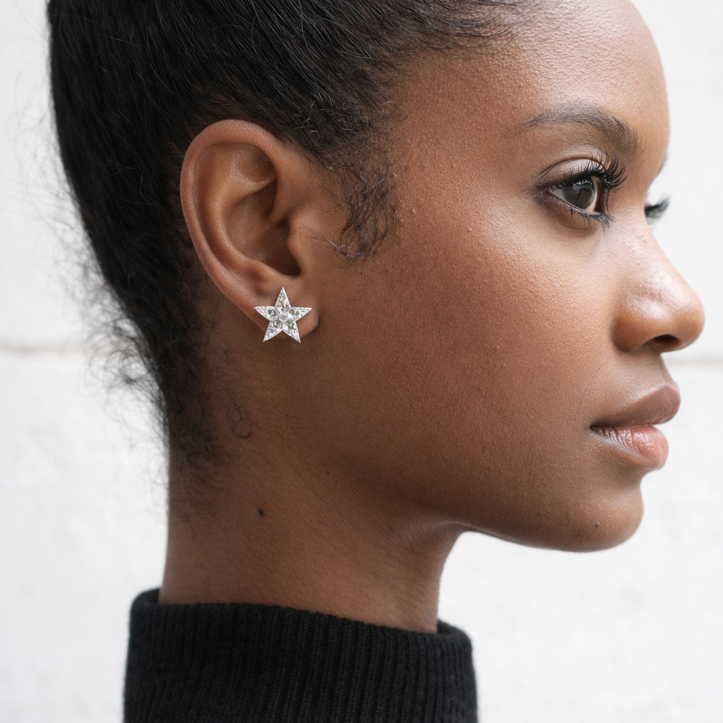 Close-up of a woman wearing Aurelia stud earrings. 