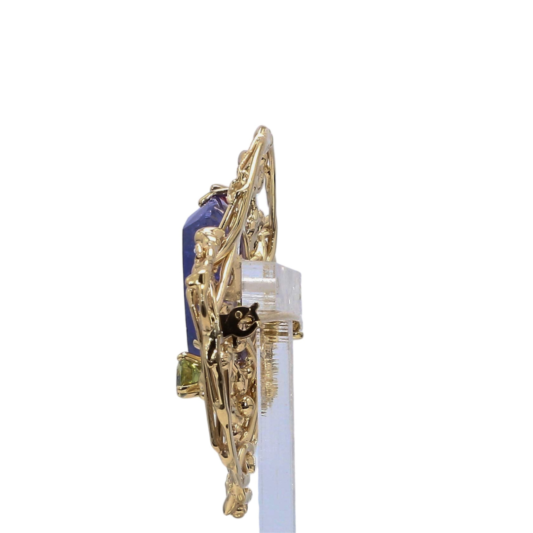 Laurenti bespoke tanzanite brooch featuring pink and green gemstones in an 18K yellow gold sculptural design.