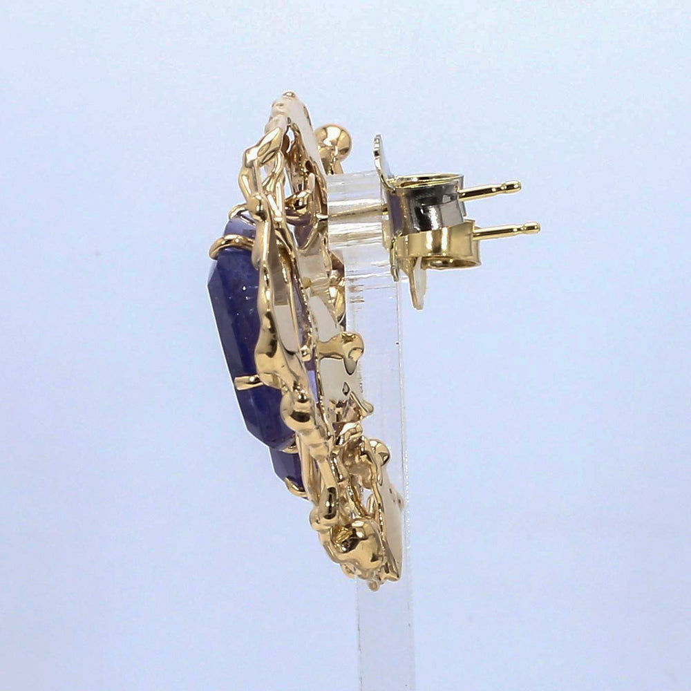 
                  
                    Laurenti bespoke tanzanite sculptural earrings set in hand-sculpted 18K yellow gold.
                  
                