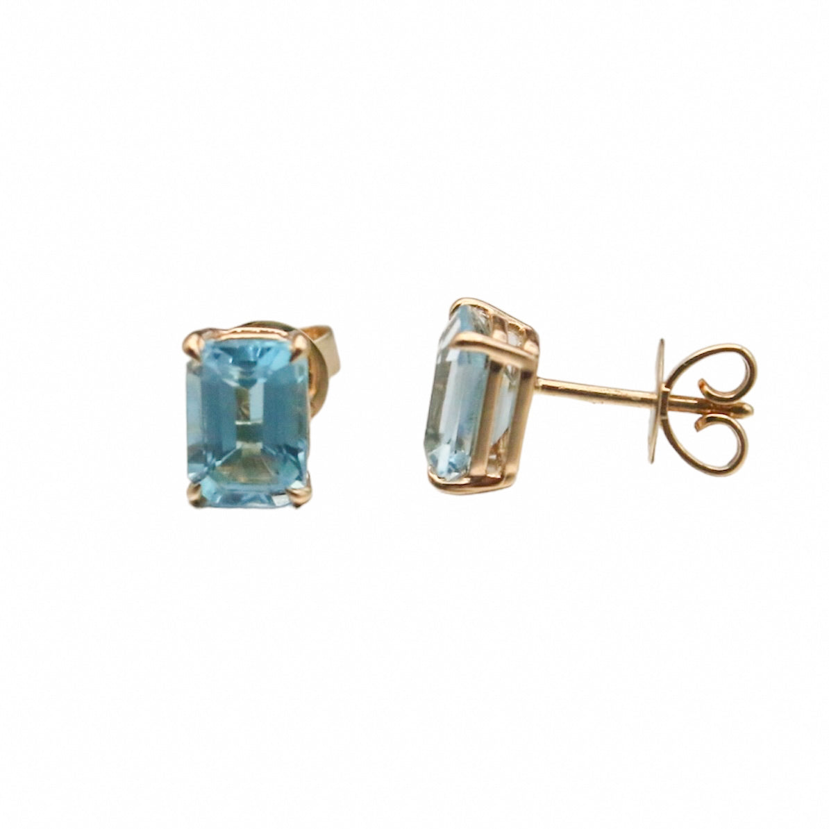 Laurenti blue topaz emerald-cut birthstone stud earrings set in 14K yellow gold.