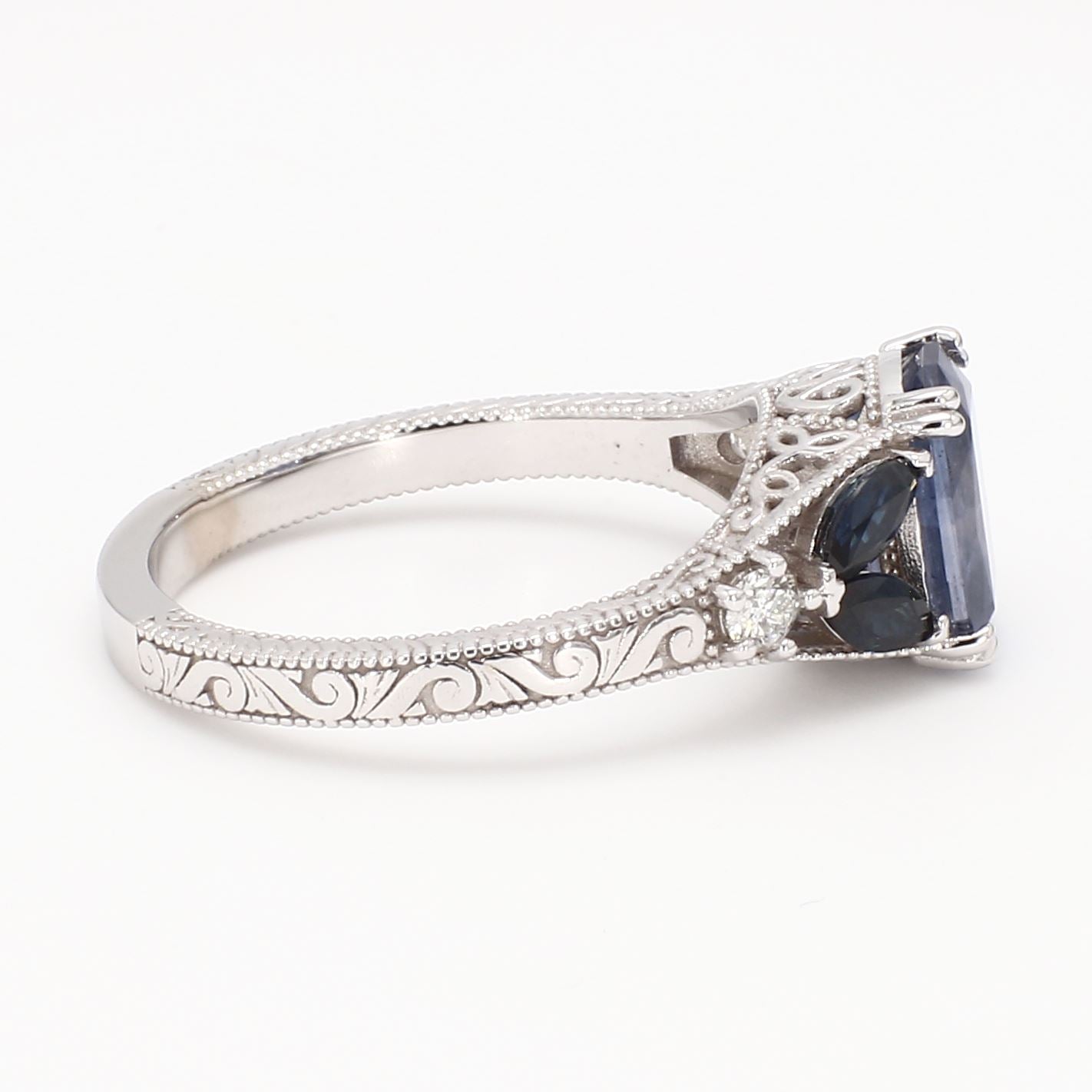 Vintage-inspired 14K white gold engagement ring featuring a natural blue sapphire center stone with diamond halo and milgrain detailing.