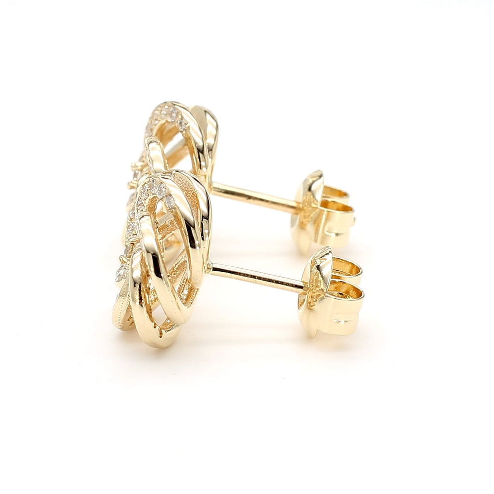 
                  
                    Camellia-inspired diamond stud earrings in 14k yellow gold with round brilliant diamonds, designed by Laurenti New York.
                  
                