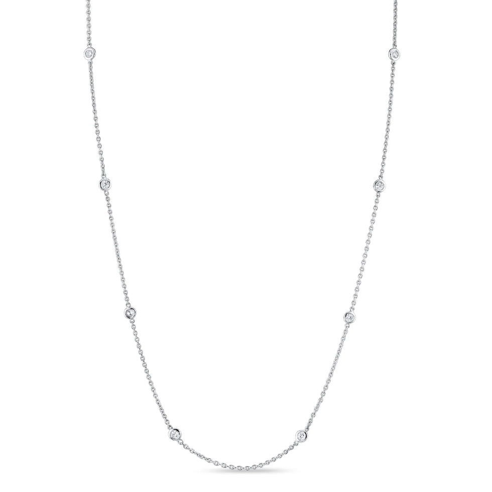 Delicate 14K gold diamond bezel station necklace featuring round brilliant diamonds set along an adjustable chain.
