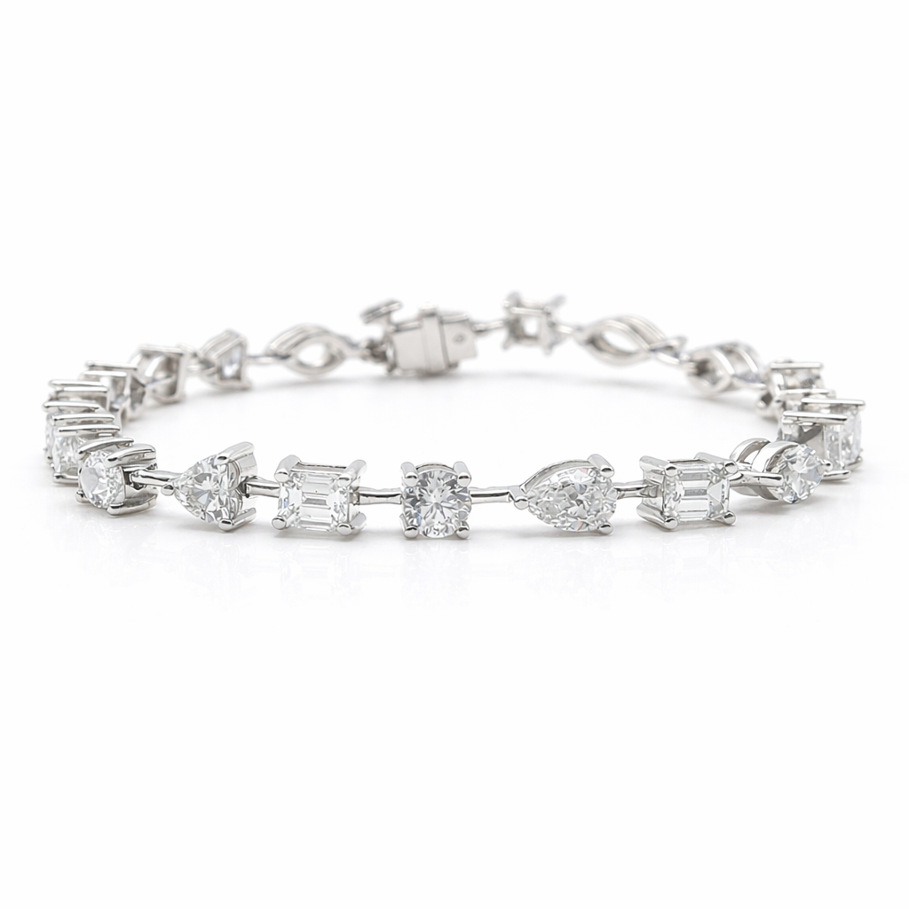 fancy shape diamond tennis bracelet with pear oval emerald cushion and marquise diamonds in 18k white gold