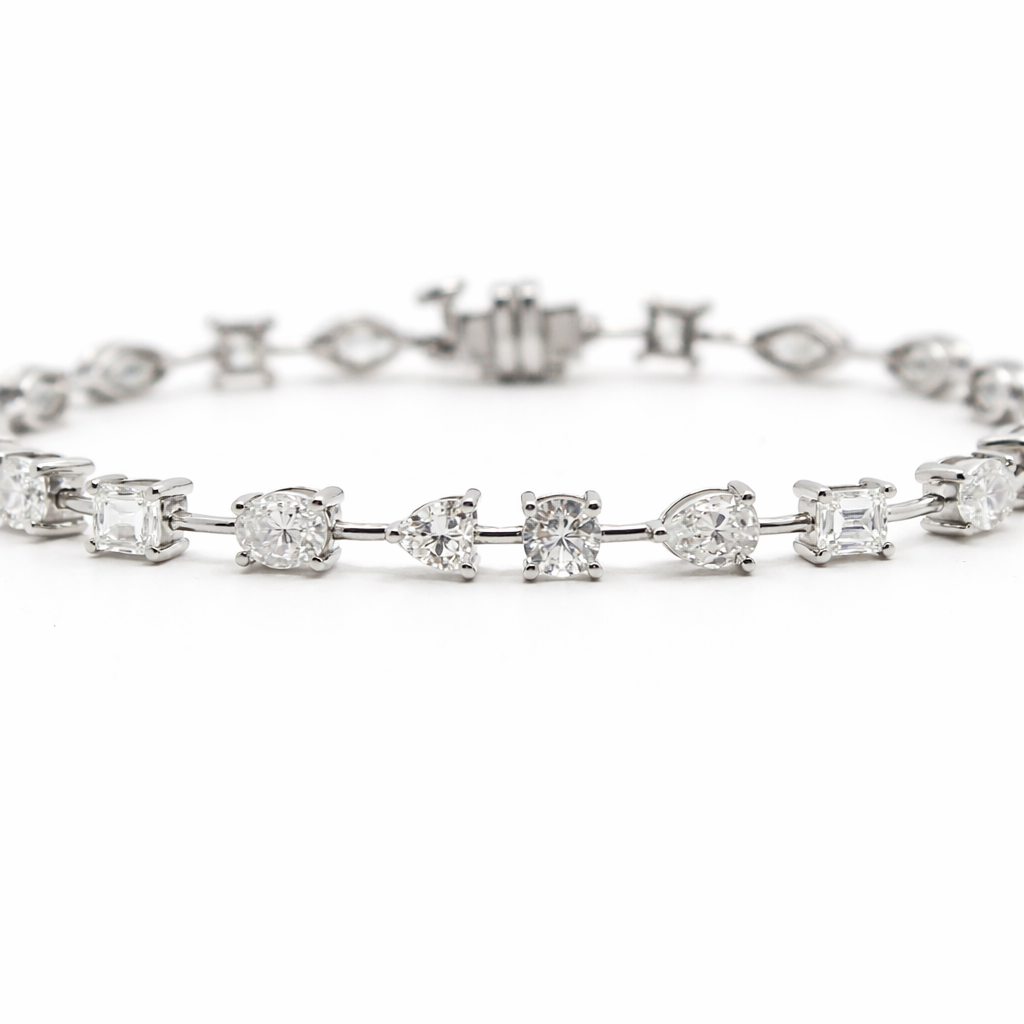 fancy shape diamond tennis bracelet with pear oval emerald cushion and marquise diamonds in 18k white gold