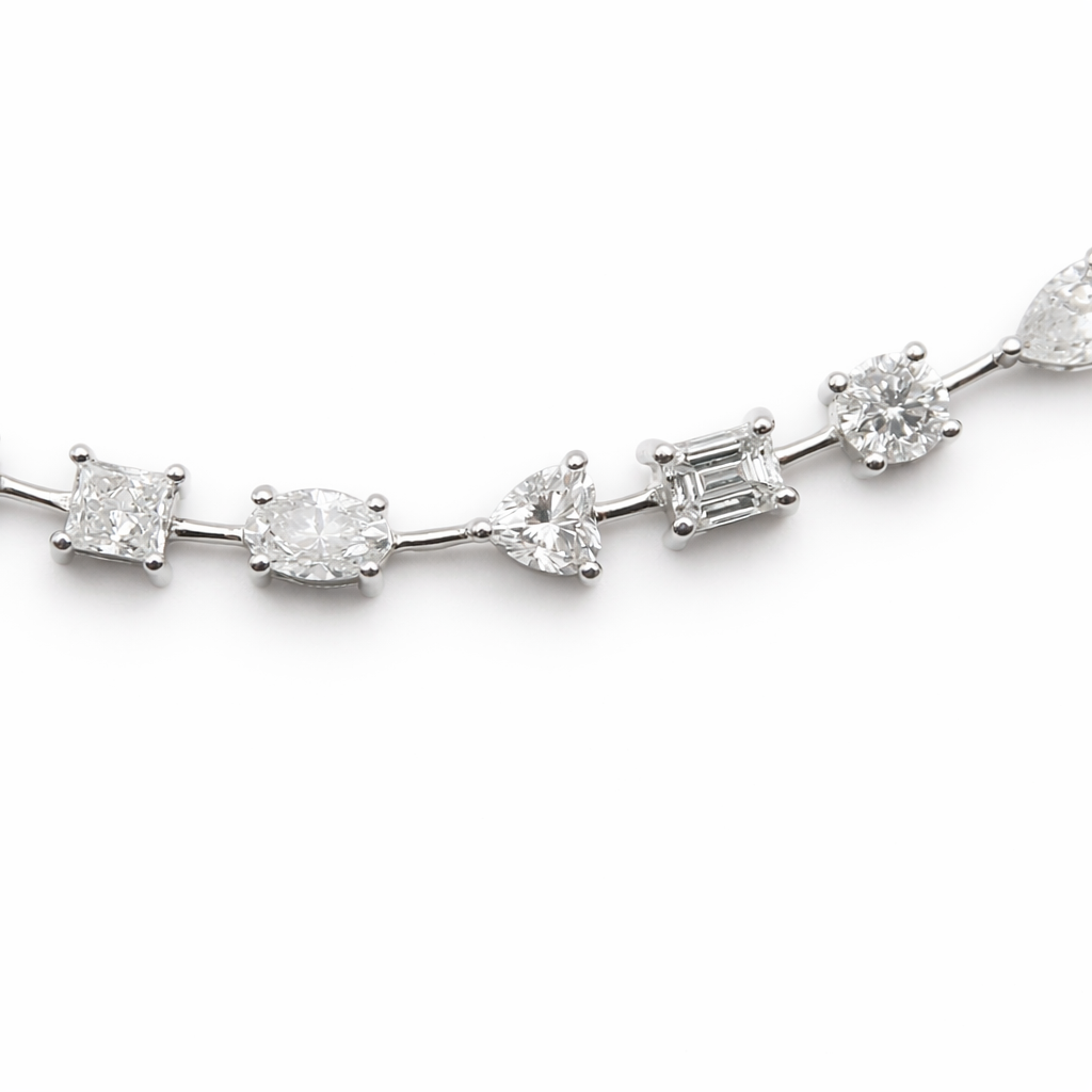 fancy shape diamond tennis bracelet with pear oval emerald cushion and marquise diamonds in 18k white gold
