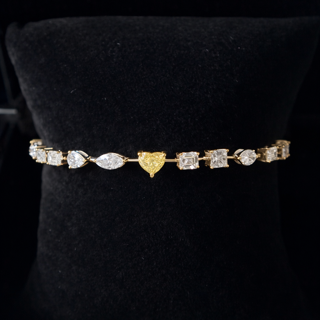 Gold and diamond tennis bracelet on a black stand