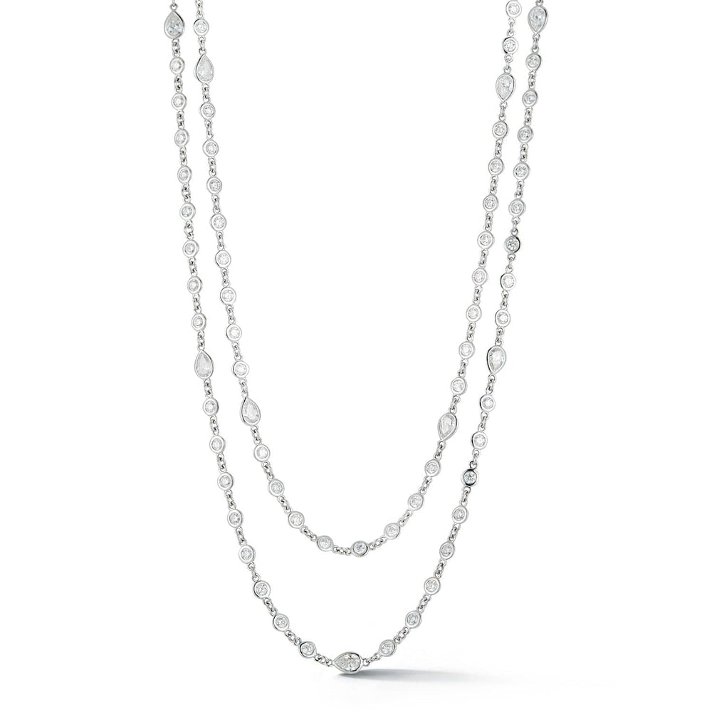 Long diamond station necklace featuring 240 round bezel-set diamonds totaling 8.36 carats in 14k white gold by Laurenti New York.