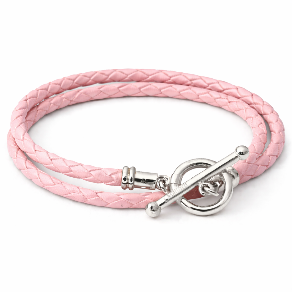 Pink braided leather bracelet with silver clasp on a white background