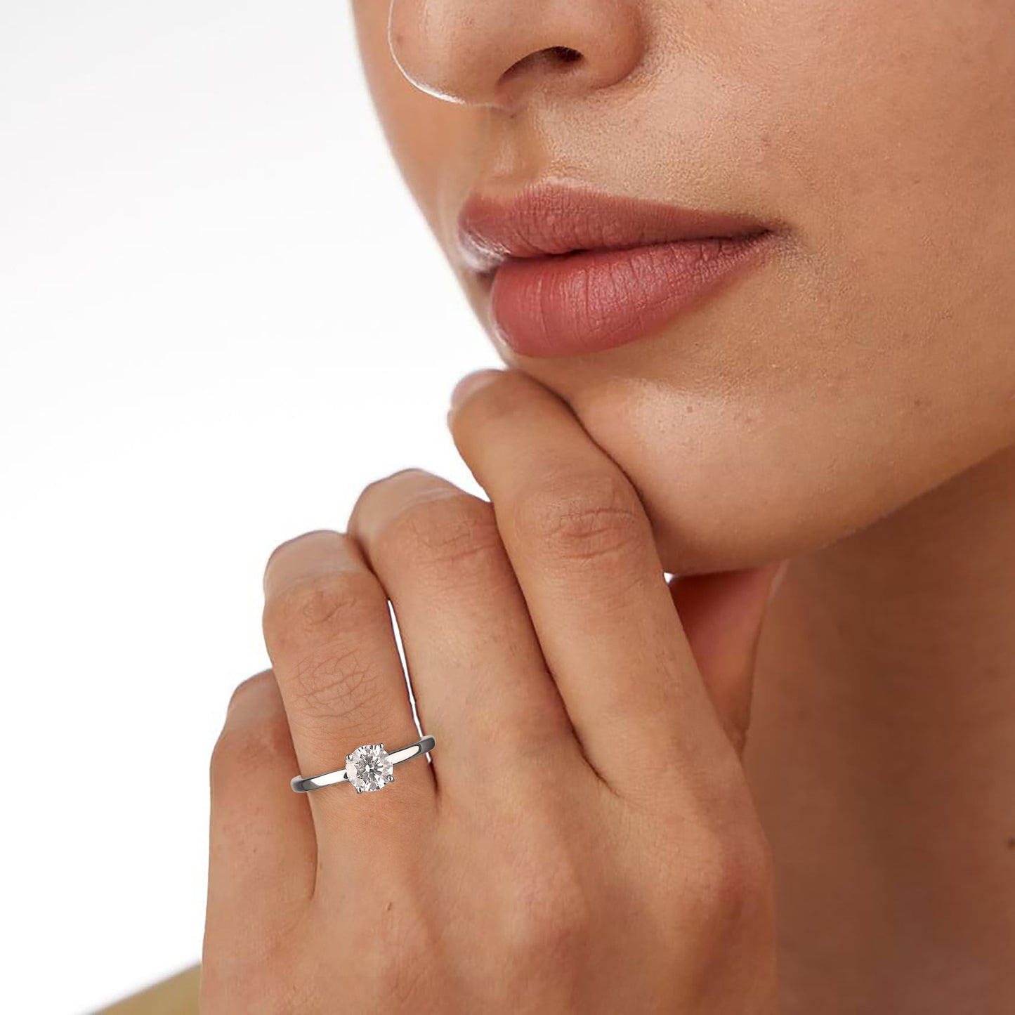 Close-up of a hand wearing a diamond ring with a blurred background