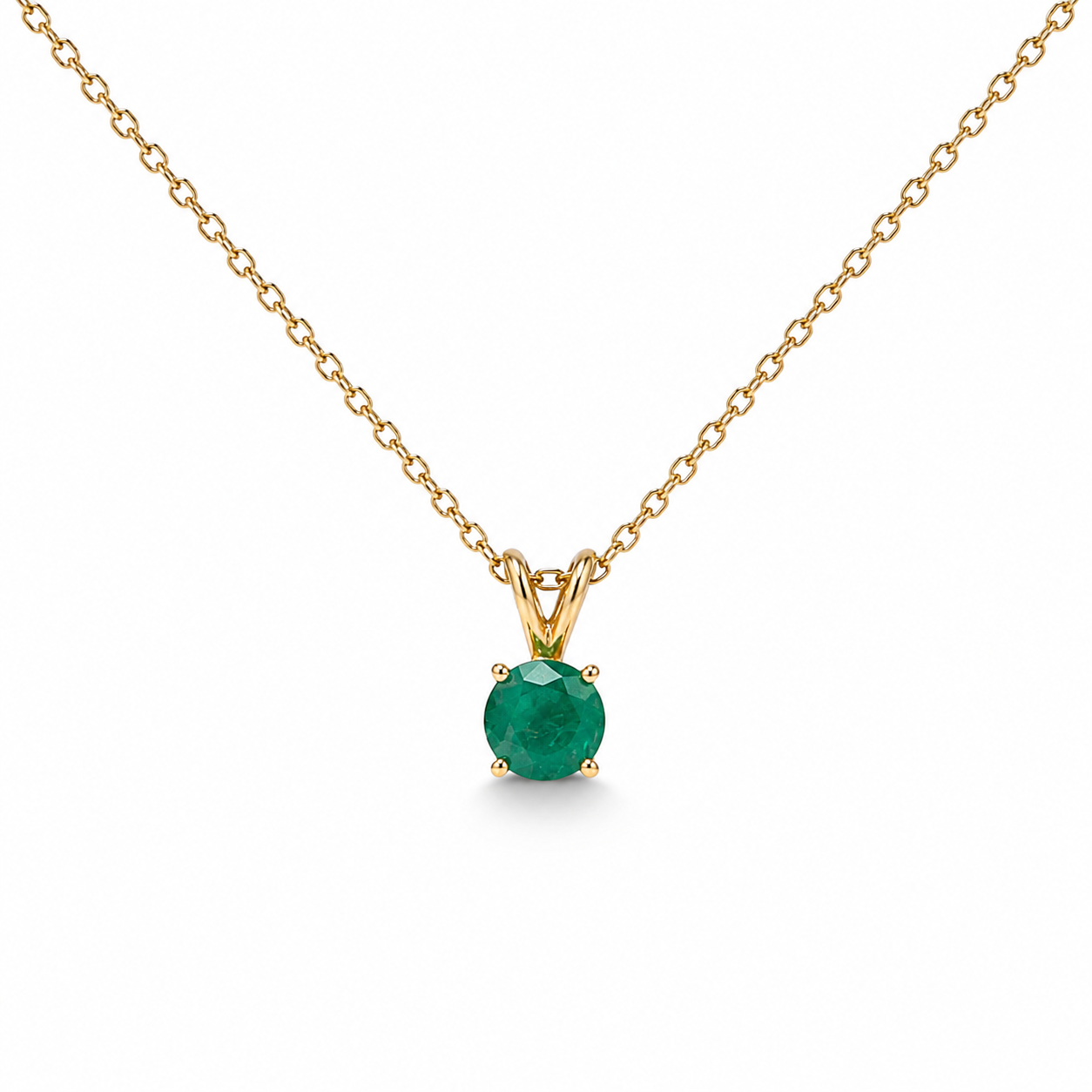 Natural round Colombian emerald solitaire pendant set in 14K yellow gold on a delicate cable chain, handcrafted in New York by Laurenti New York.