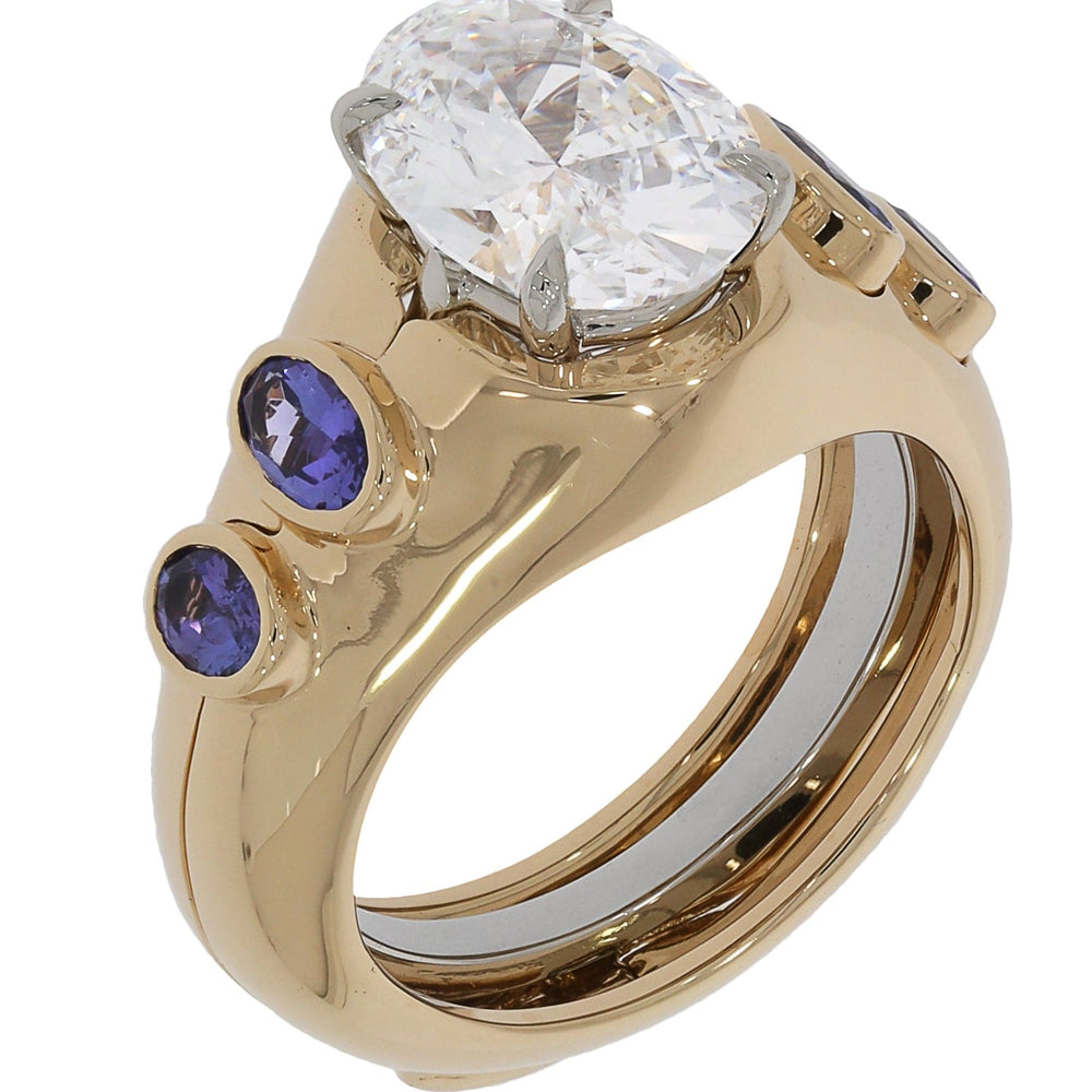 
                  
                    18K Yellow Gold Tanzanite Ring Jacket by Laurenti New York featuring bezel-set violet-blue tanzanite accents around a solitaire setting.
                  
                