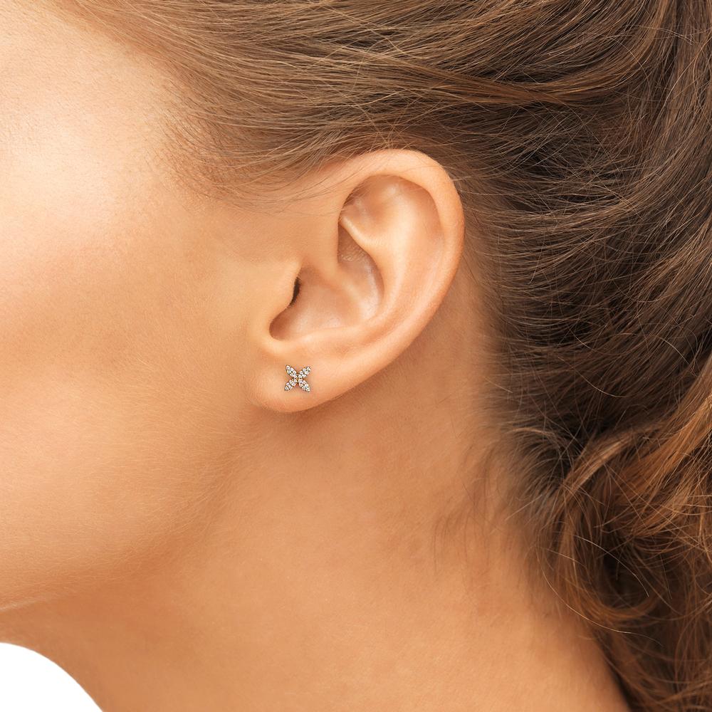 Close-up of Laurenti’s Mini Pave Diamond Studs in 14k yellow gold, featuring four petal-shaped points set with brilliant diamonds on a model. 