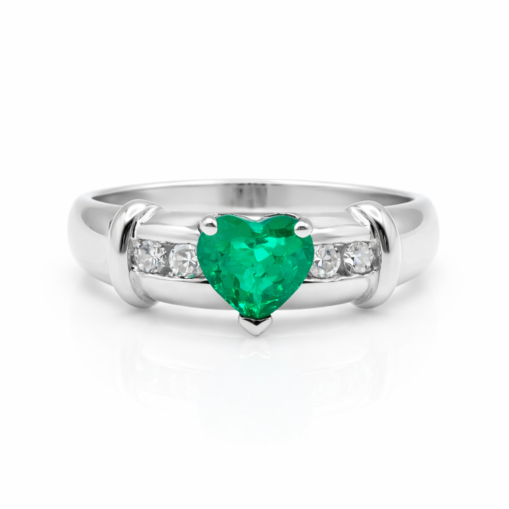 heart shaped emerald ring with diamond accents in 18k white gold