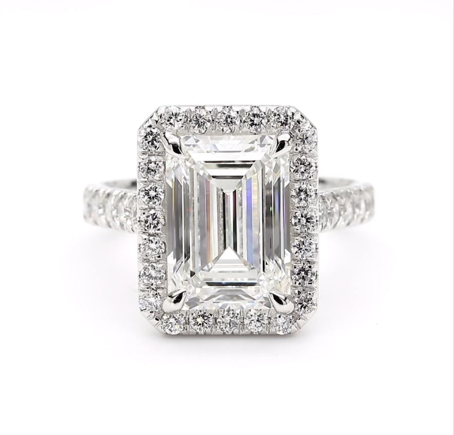 360 view of platinum emerald cut diamond engagement ring with halo