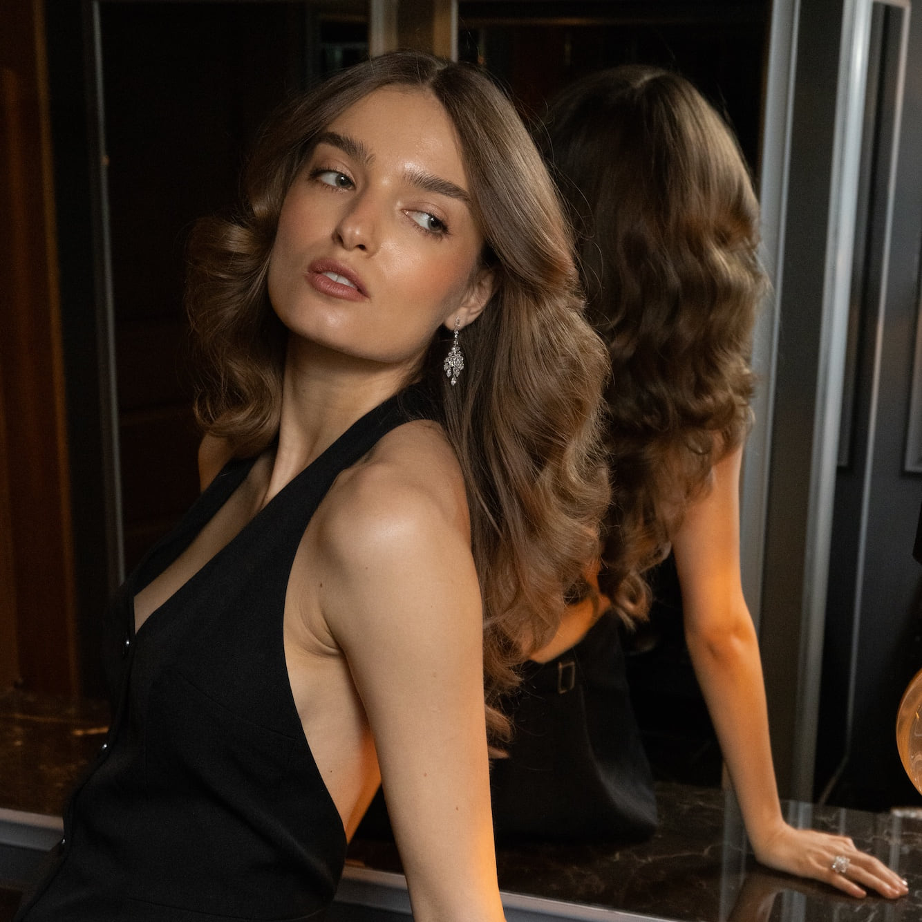 Model wearing Laurenti diamond earrings in a New York portrait