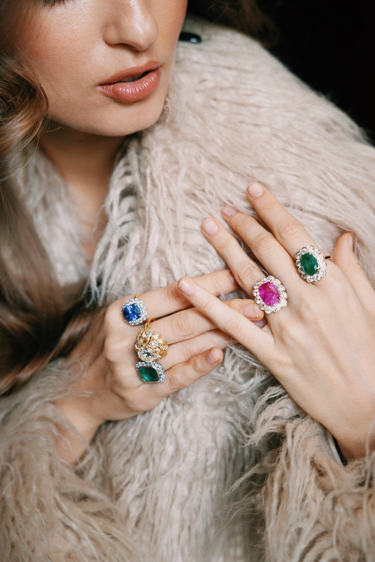 Model wearing a private selection of Laurenti emerald, ruby and sapphire rings