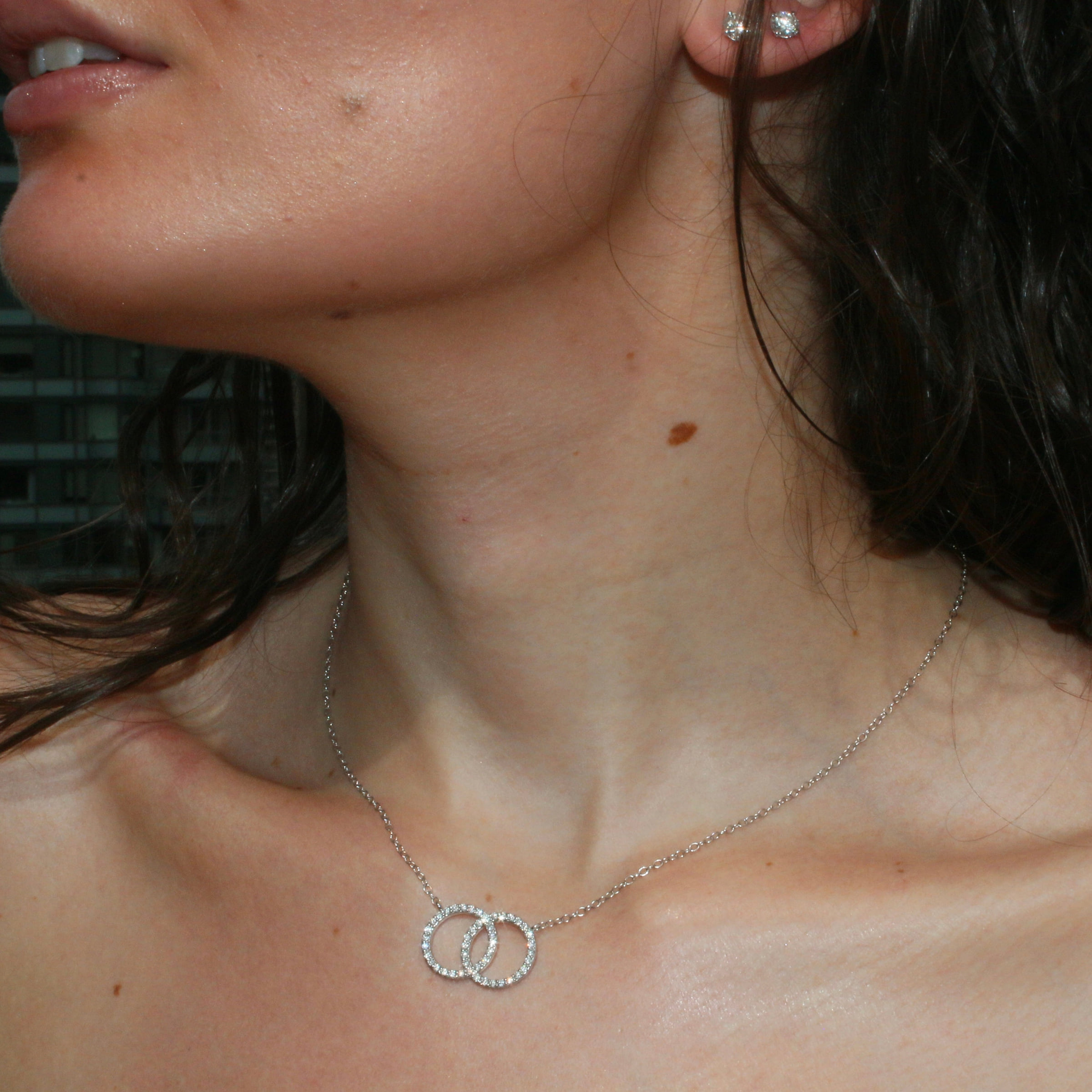The Karma Diamond Necklace in 14k Gold, shown on the wearer